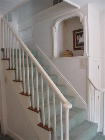 45 Shaker Lane Littleton, MA 01460 - Photo 3 of 30 a view of staircase with lots of frames on wall and a view of bedroom