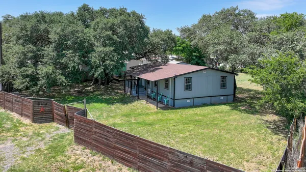 a view of a backyard with a wooden fence