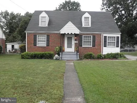 a front view of a house with a garden and plants