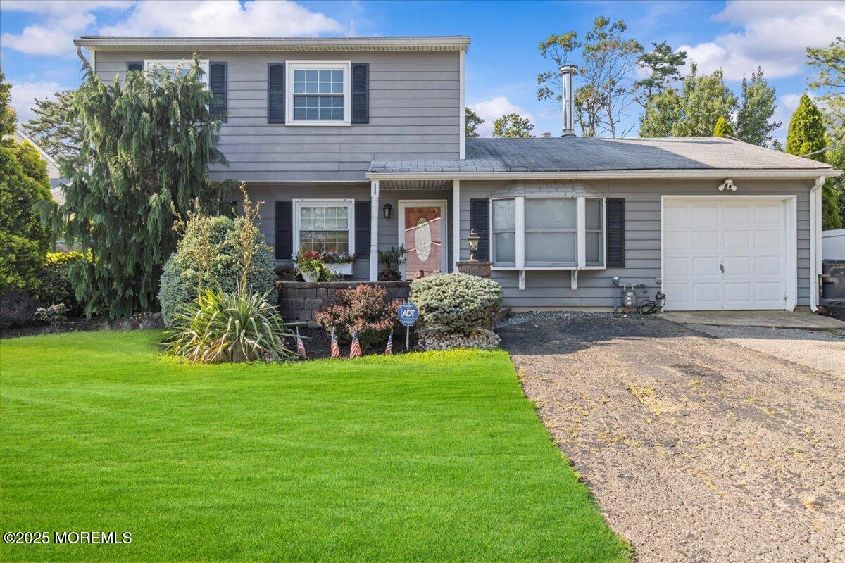 a view of a house with a yard and plants