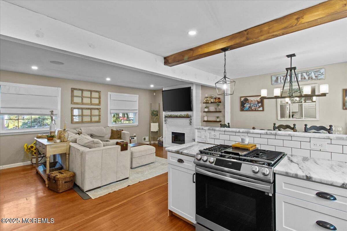 2110 Lanes Mill Road Brick, NJ 08724 - Photo 11 of 55 a kitchen with a stove and a wooden floor
