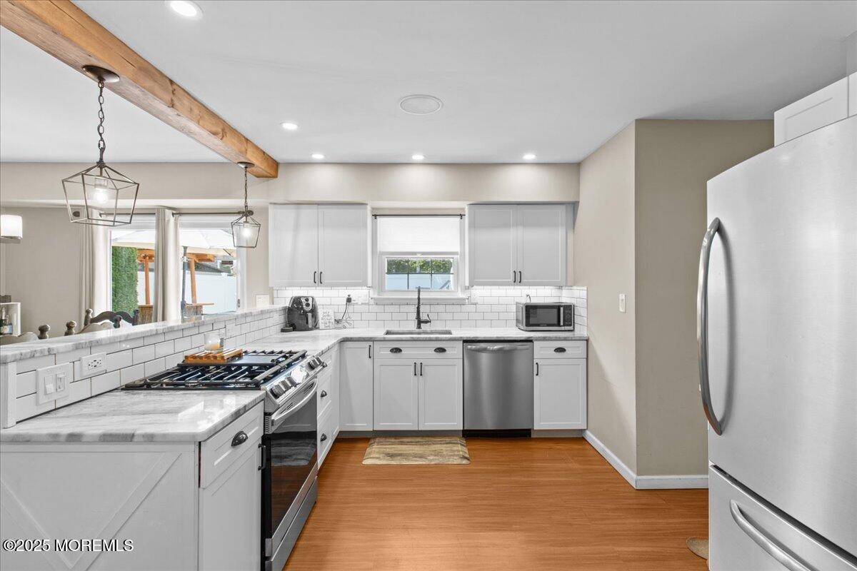 2110 Lanes Mill Road Brick, NJ 08724 - Photo 12 of 55 a kitchen with stainless steel appliances granite countertop a sink stove and refrigerator