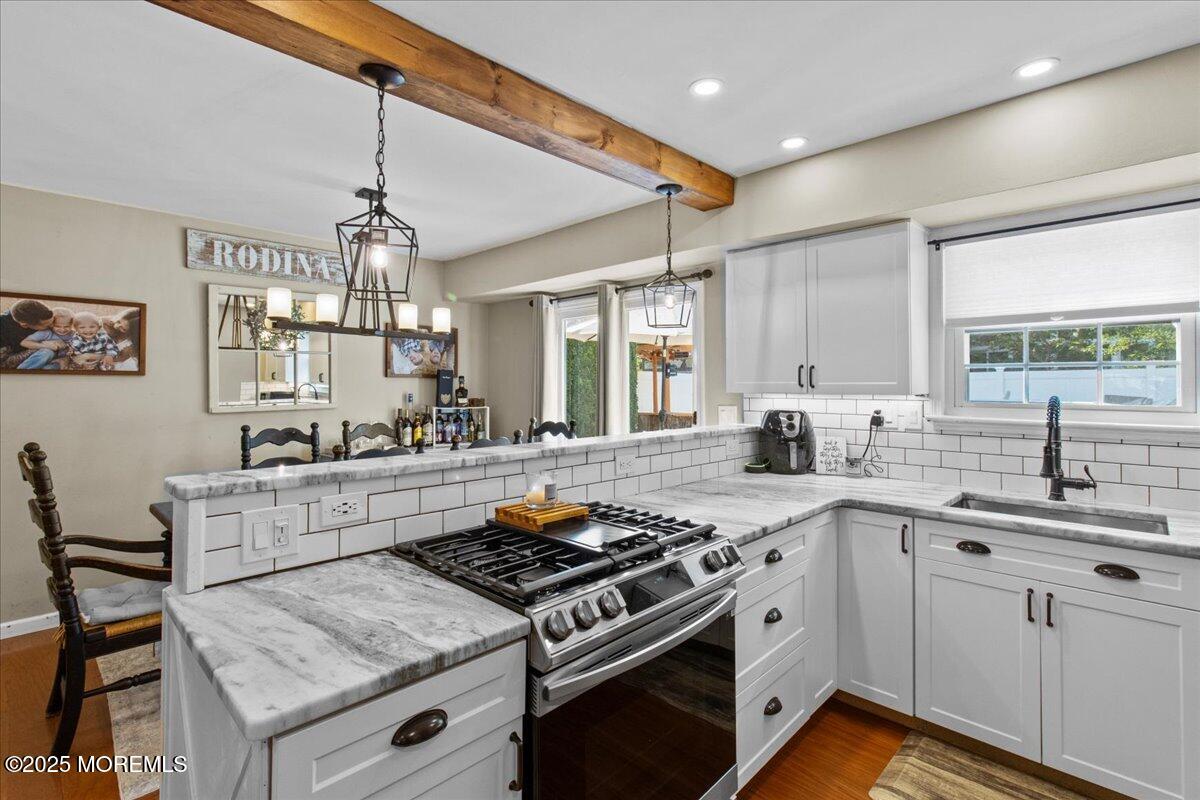 2110 Lanes Mill Road Brick, NJ 08724 - Photo 13 of 55 a kitchen with a stove sink and cabinets