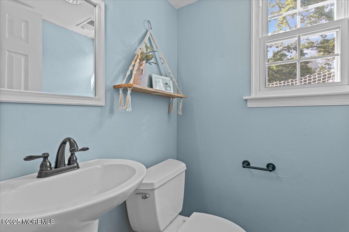 2110 Lanes Mill Road Brick, NJ 08724 - Photo 17 of 55 a white toilet sitting next to a bathroom sink