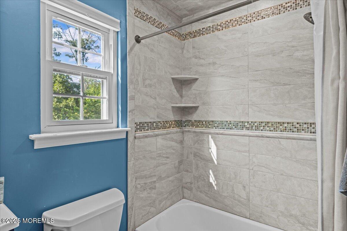 2110 Lanes Mill Road Brick, NJ 08724 - Photo 23 of 55 a bathroom with a granite countertop bathtub a window and a shower