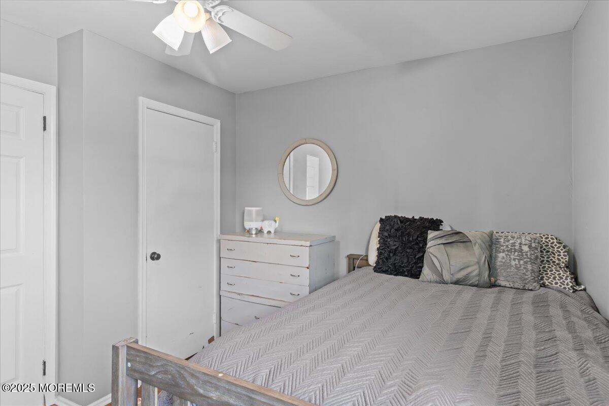2110 Lanes Mill Road Brick, NJ 08724 - Photo 26 of 55 a bedroom with a bed and a chandelier