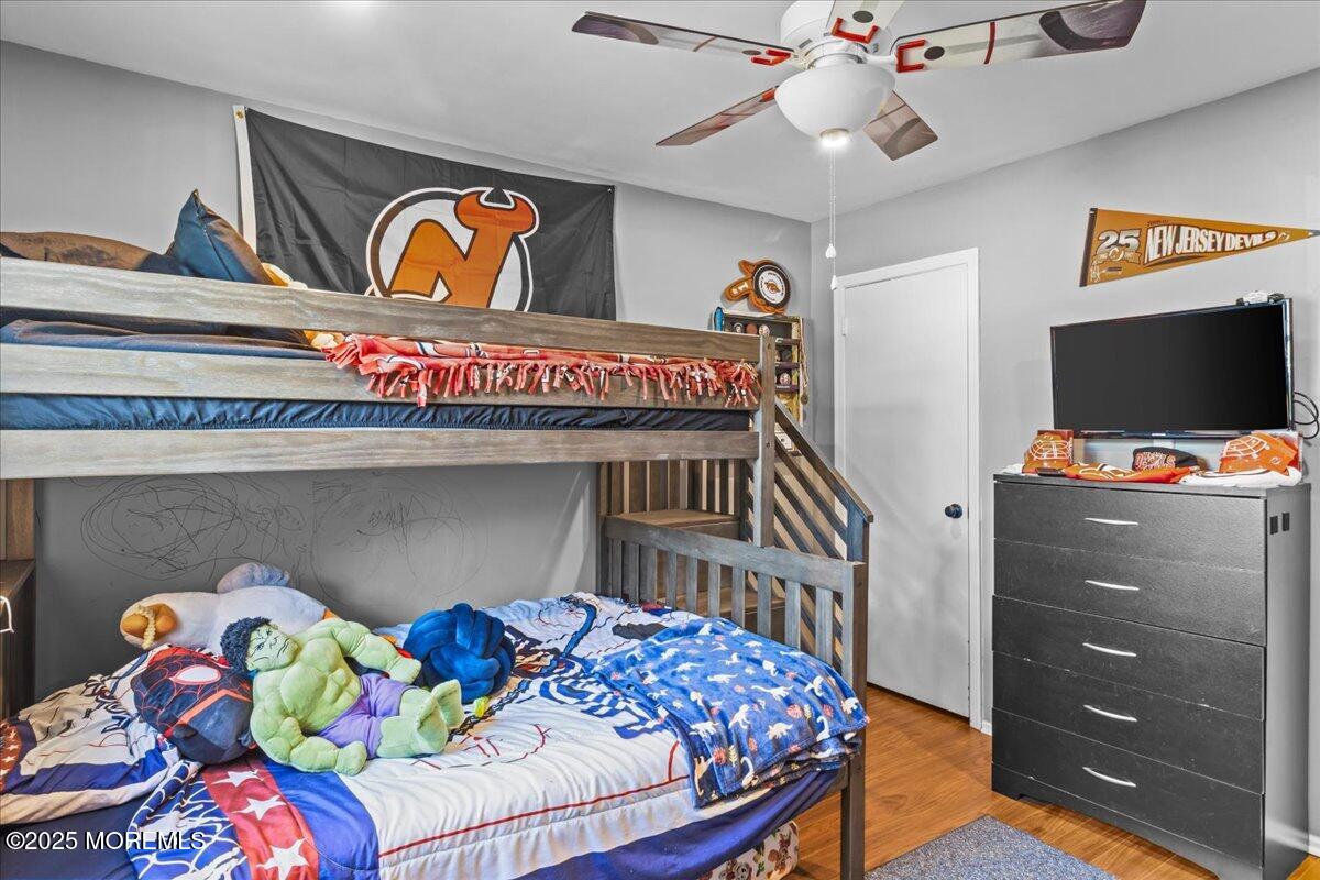 2110 Lanes Mill Road Brick, NJ 08724 - Photo 29 of 55 a bedroom with a bed and flat screen tv