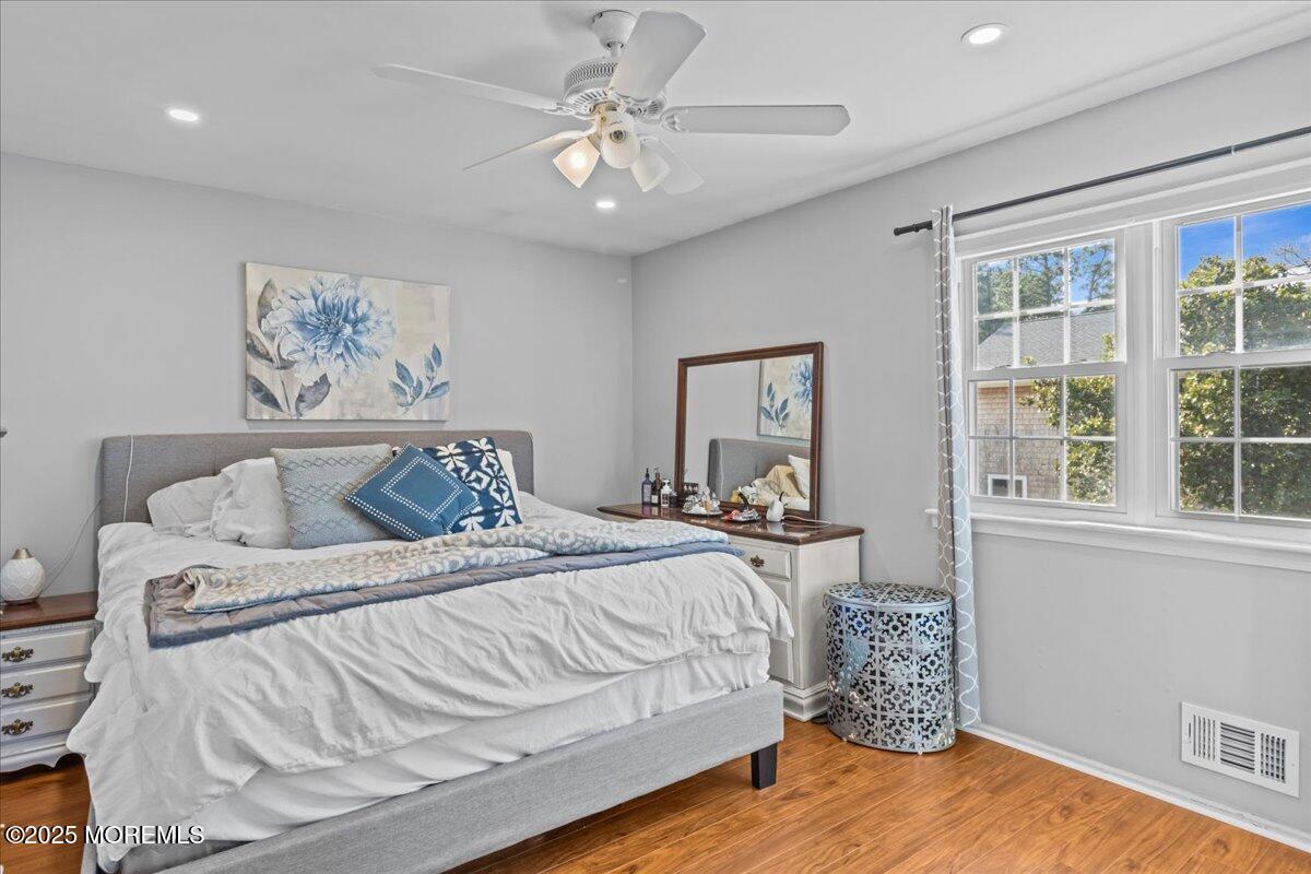 2110 Lanes Mill Road Brick, NJ 08724 - Photo 30 of 55 a bedroom with a bed and a chandelier
