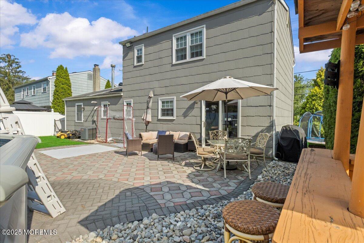 2110 Lanes Mill Road Brick, NJ 08724 - Photo 32 of 55 a view of a patio with couches table and chairs under an umbrella