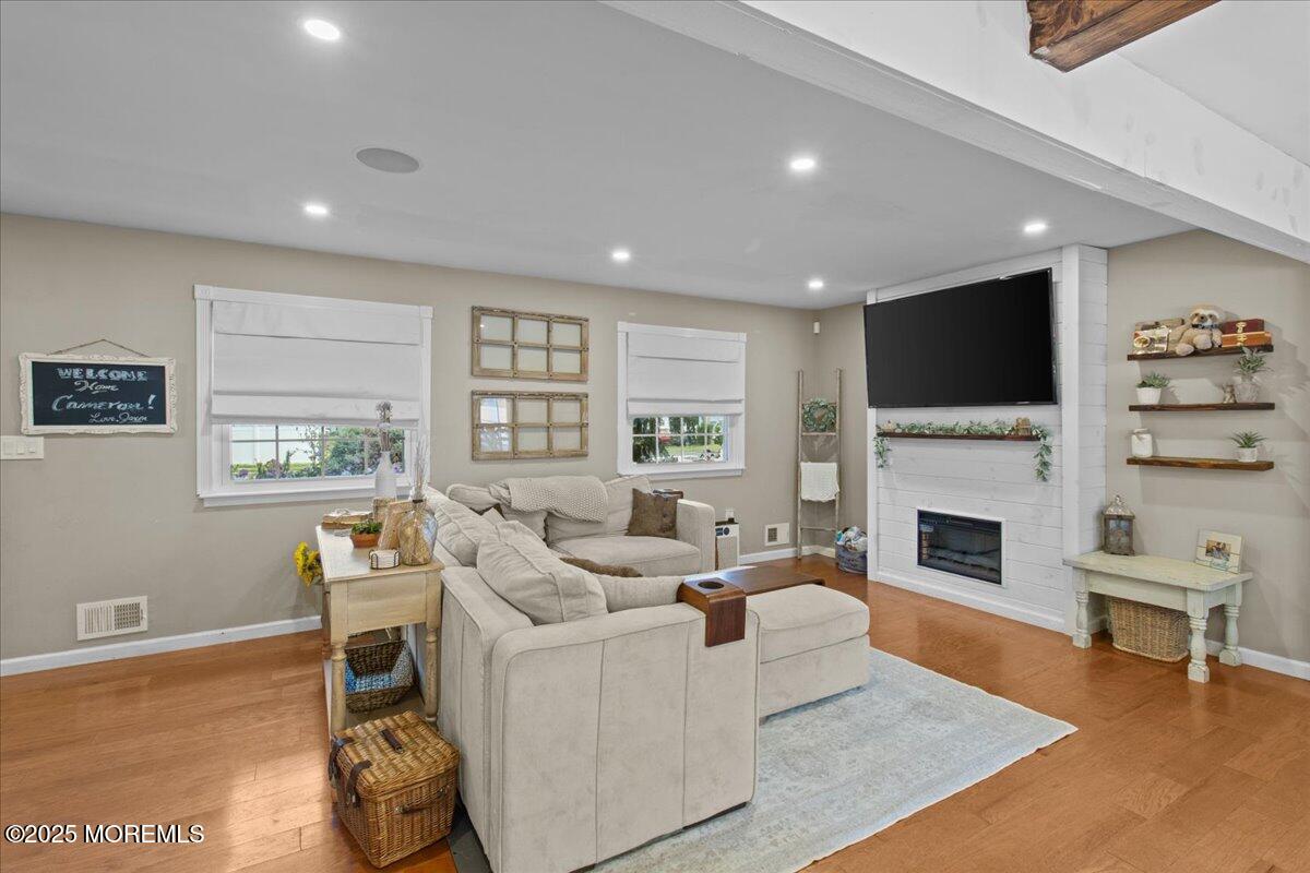 2110 Lanes Mill Road Brick, NJ 08724 - Photo 7 of 55 a living room with furniture a fireplace and a flat screen tv
