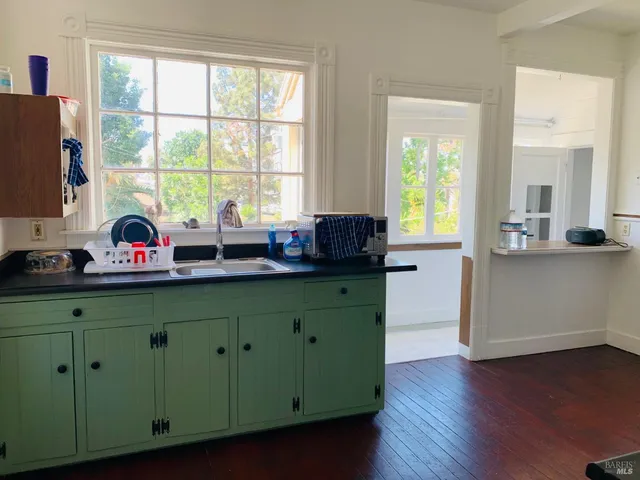 a kitchen with stainless steel appliances wooden cabinets sink and window