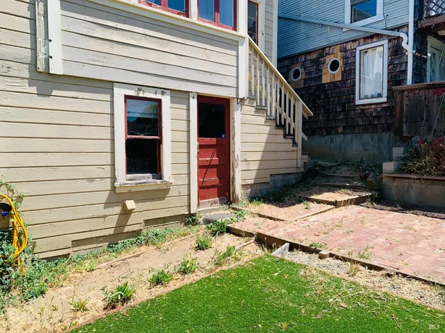 a view of a house with a yard and chair