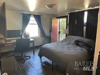 a bed sitting in a room next to a window