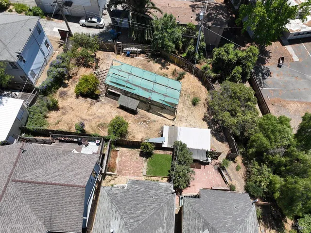 an aerial view of a house with a yard