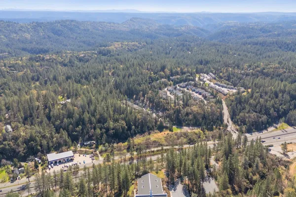 a front view of a building with trees