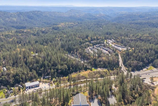a front view of a building with trees