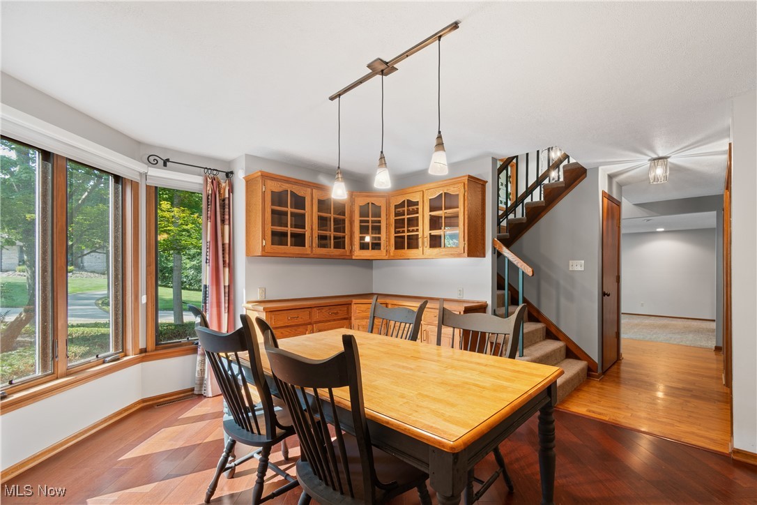 2317 Raintree Street Northeast Canton, OH 44705 - Photo 8 of 40 Dining space featuring light wood-style floors and stairway