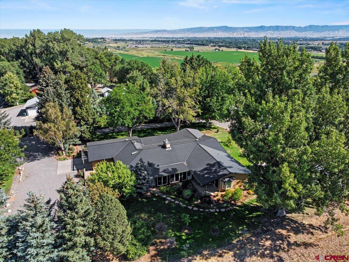16470 6300th Road Montrose, CO 81403 - Photo 1 of 35 an aerial view of a house with garden