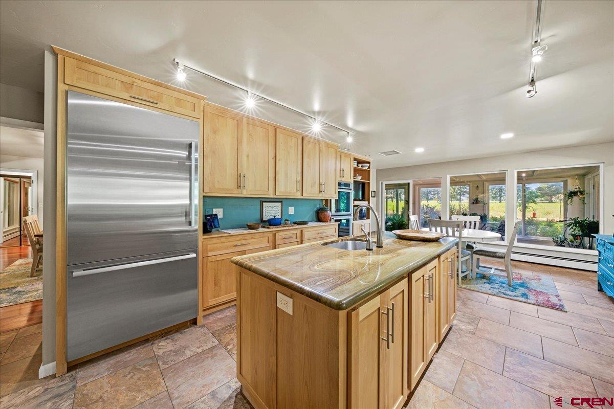 16470 6300th Road Montrose, CO 81403 - Photo 11 of 35 a kitchen with kitchen island sink and refrigerator