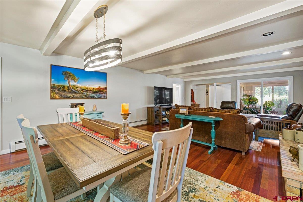 16470 6300th Road Montrose, CO 81403 - Photo 15 of 35 a view of a dining room with furniture a chandelier and wooden floor