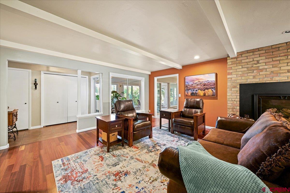 16470 6300th Road Montrose, CO 81403 - Photo 16 of 35 a living room with furniture a large window and wooden floor