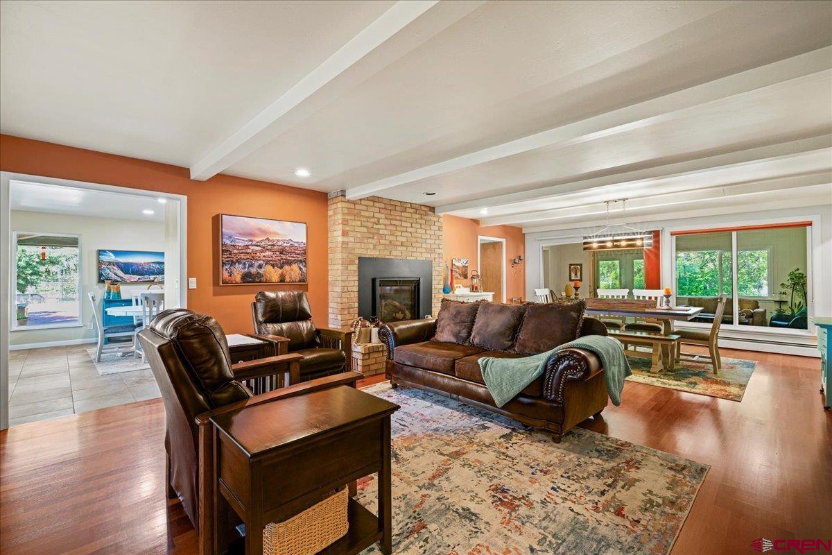 16470 6300th Road Montrose, CO 81403 - Photo 18 of 35 a living room with fireplace furniture and a wooden floor