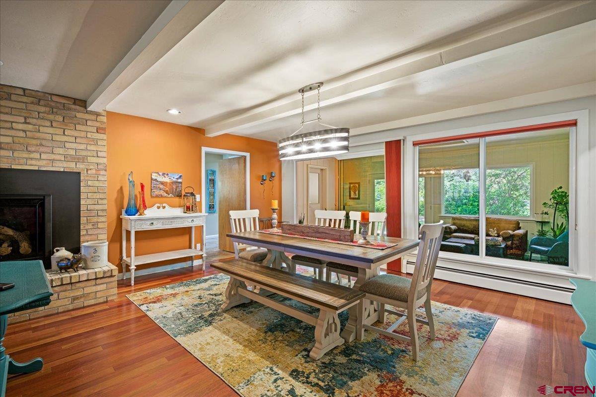 16470 6300th Road Montrose, CO 81403 - Photo 19 of 35 a view of a dining room with furniture one side kitchen view and wooden floor