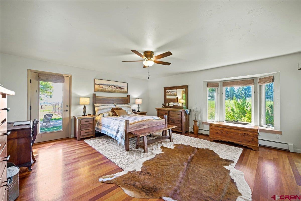 16470 6300th Road Montrose, CO 81403 - Photo 21 of 35 a living room with a bed furniture and a large window
