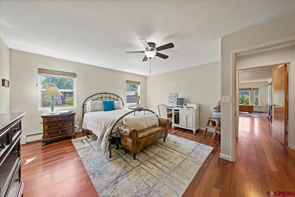 16470 6300th Road Montrose, CO 81403 - Photo 24 of 35 a bedroom with a bed and wooden floor