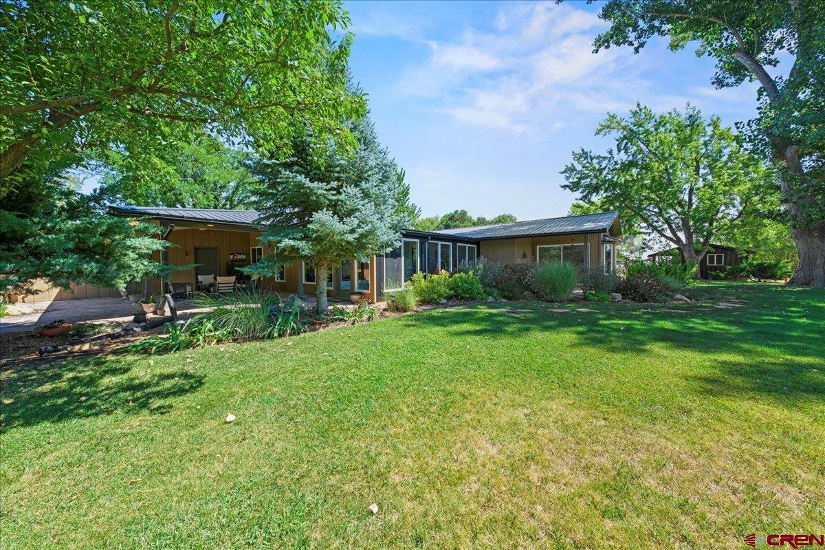 16470 6300th Road Montrose, CO 81403 - Photo 32 of 35 a view of a house with backyard and a sitting area