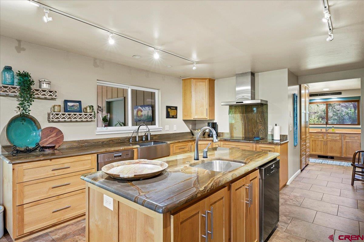 16470 6300th Road Montrose, CO 81403 - Photo 8 of 35 a kitchen with stainless steel appliances granite countertop a sink a stove and a wooden cabinets