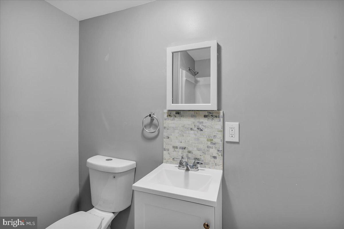407 Powell Street Gloucester City, NJ 08030 - Photo 11 of 22 a bathroom with a toilet sink and mirror