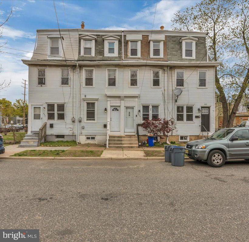 407 Powell Street Gloucester City, NJ 08030 - Photo 2 of 22 a car parked in front of a house