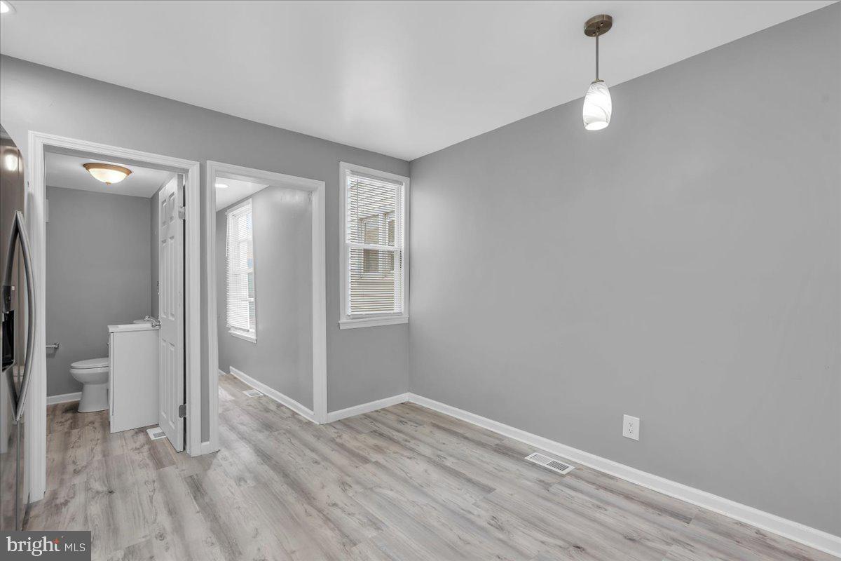 407 Powell Street Gloucester City, NJ 08030 - Photo 9 of 22 a view of livingroom with hardwood floor and window