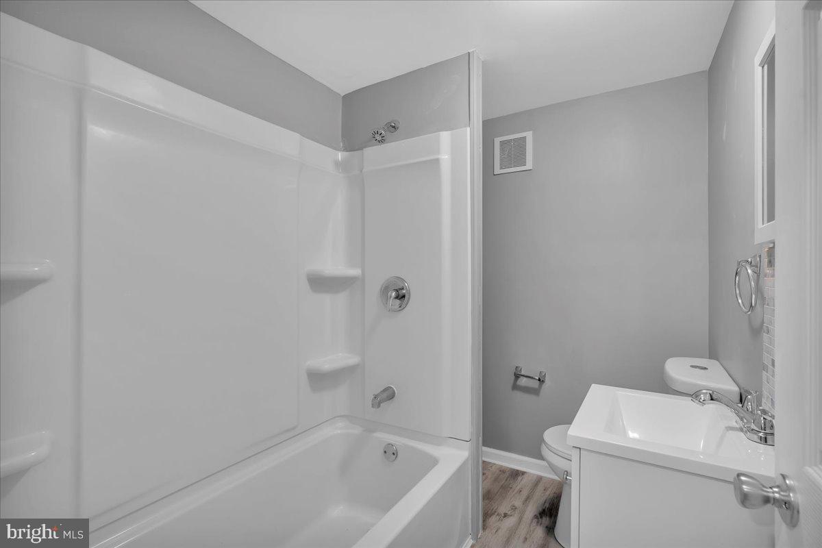 407 Powell Street Gloucester City, NJ 08030 - Photo 10 of 22 a bathroom with a sink and a toilet