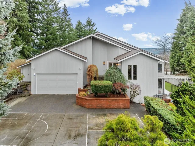 a white house with a small yard and a garden