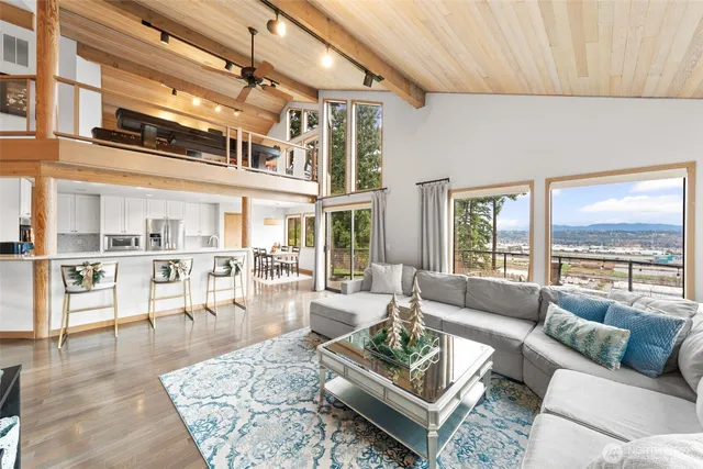 a living room with furniture wooden floor and a table