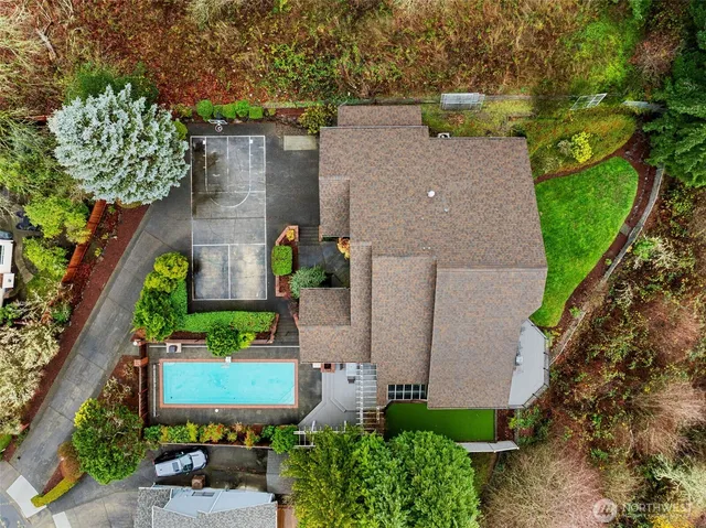 an aerial view of a house with a yard and potted plants