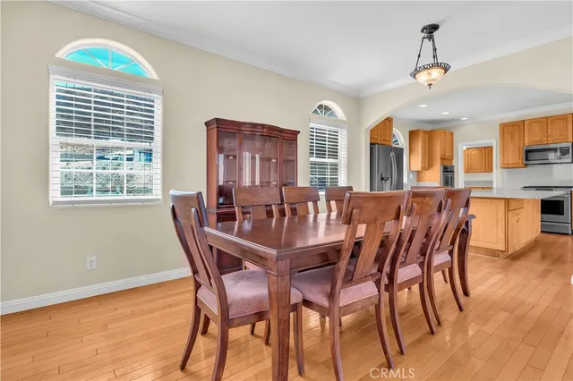 a kitchen with stainless steel appliances a stove a sink a microwave and wooden cabinets