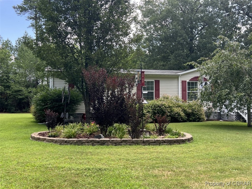 102 Mechams Cove Road Topping, VA 23169 - Photo 22 of 40 View of side of home featuring a yard