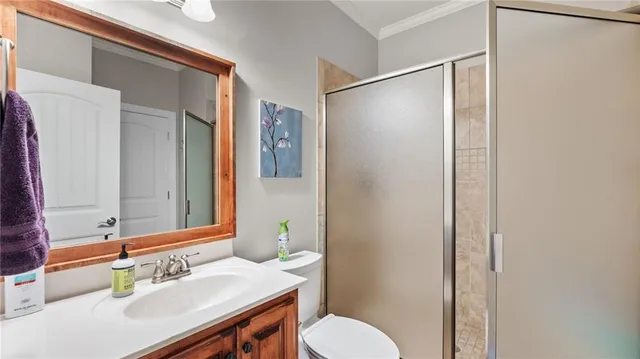 a bathroom with a sink vanity mirror and toilet