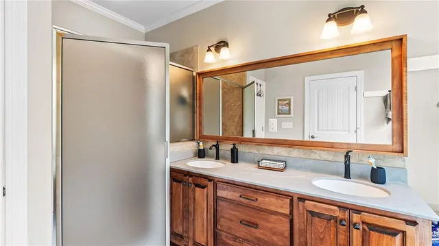 a bathroom with a double vanity sink and a mirror