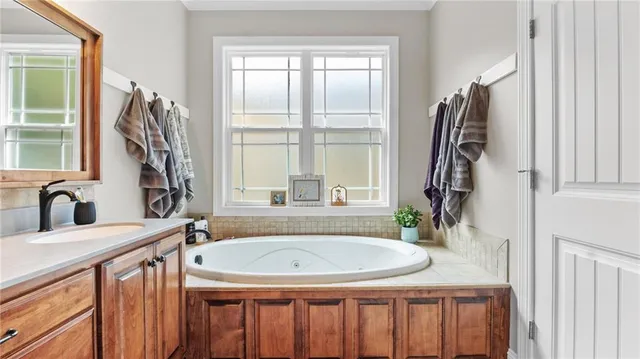a bathroom with a sink a mirror and a window
