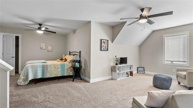 a bedroom with bed and a chandelier