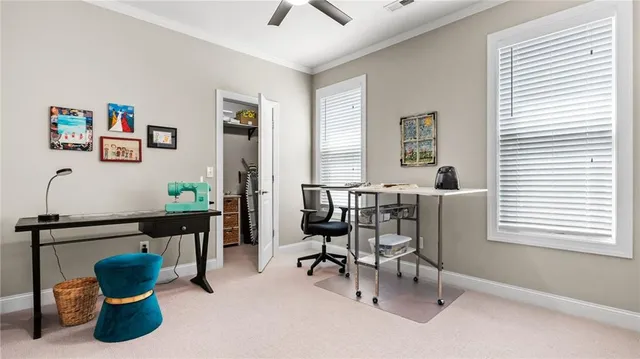 a view of a dining room with furniture and a window