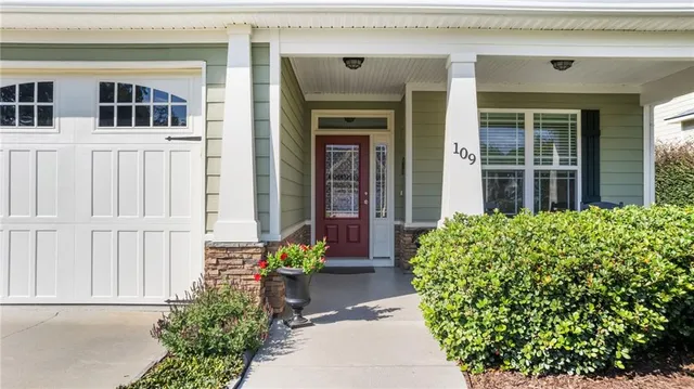 front view of a house with a potted plant