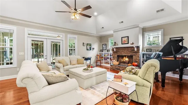 a living room with furniture fireplace and a large window