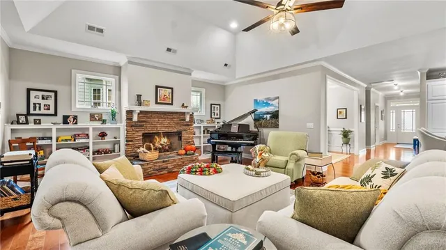 a living room with furniture a fireplace and a flat screen tv