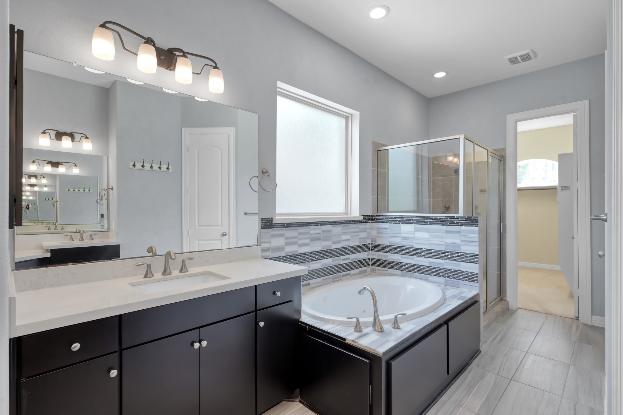 23219 Belted Kingfisher Trail Spring, TX 77389 - Photo 18 of 44 Primary bath features dual sinks with individual vanity space, along with a jetted tub and separate walk-in shower.