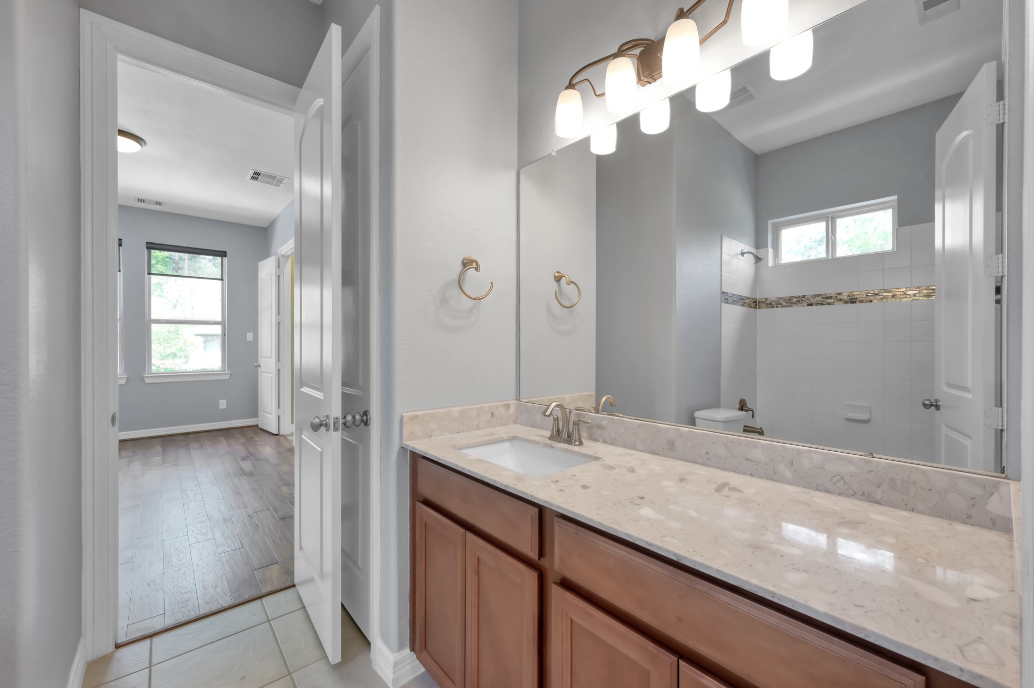 23219 Belted Kingfisher Trail Spring, TX 77389 - Photo 21 of 44 Downstairs secondary bath with convenient access from both the flex space and a secondary bedroom.